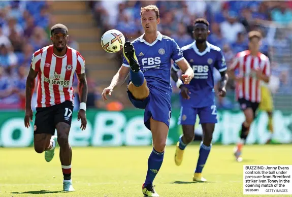  ?? GETTY IMAGES ?? BUZZING: Jonny Evans controls the ball under pressure from Brentford striker Ivan Toney in the opening match of the season