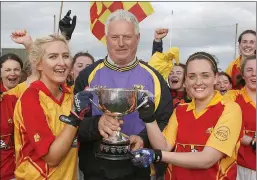  ??  ?? Joint captains Chloe Power and Sarah Martin accepting the cup from Denis Nolan.