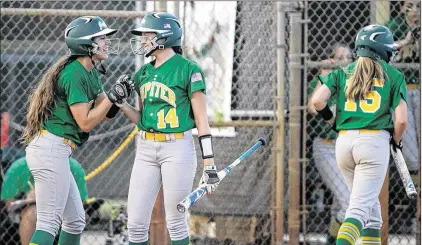  ?? MICHAEL ARES / THE PALM BEACH POST ?? Shelby Russo (14) of Jupiter celebrates with teammates Riley Bennett (left) and Madi McCants (15) after the Warriors scored their first two runs of the game in the third inning. Wednesday’s 5-0 victory puts Jupiter in the 9A regional semifinals.