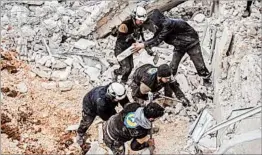  ?? OMAR HAJ KADOUR/GETTY-AFP ?? Syrian volunteers dig through the rubble of a mosque following a reported airstrike.