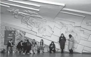  ?? ALINA SMUTKO/REUTERS ?? People take shelter inside a metro station during an air raid alert Tuesday in Kyiv, Ukraine.