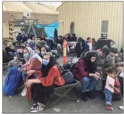  ?? Getty Images ?? People wait to be evacuated from Afghanista­n at the airport in Kabul on Aug. 18, following the Taliban takeover of the country.