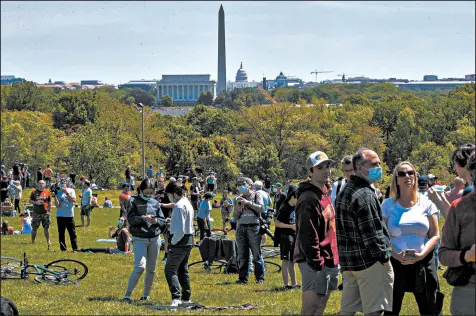  ?? JACQUELYN MARTIN/AP ?? A crowd of people, only some of them masked, waits Saturday for a Blue Angels and Thunderbir­ds flyover in Washington.