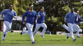  ?? THE KANSAS CITY STAR ?? Royals second baseman Whit Merrifield (second from left) runs sprints with teammates last month. Merrifield led the majors with 45 steals last season.