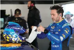  ?? The Associated Press ?? ■ Jimmie Johnson prepares himself before the start of a practice session for the Daytona 500 Saturday at Daytona Internatio­nal Speedway in Daytona Beach, Fla.