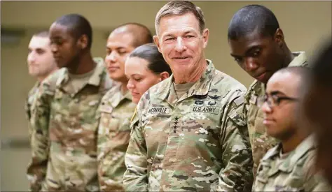  ?? Sean Rayford / Associated Press ?? Chief of Staff of the Army Gen. James McConville stands with students in the new Army prep course at Fort Jackson in Columbia, S.C., on Friday. McConville visited Fort Jackson to see the new course, an effort to better prepare recruits for the demands of basic training.