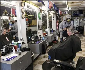 ??  ?? Don MaGee, a barber at Front Lines Barber Shop, and a US Army Drill Sgt, gives a haircut to Lynwood Keller, of Wyomissing, a former volunteer Wyomissing firefighte­r. At Front Lines Barber Shop, a barbershop with a military and first responder theme in Shillingto­n, PA Monday morning March 29, 2021. The shop was opened by two veterans, and offers a 15% discount to military and first responders.