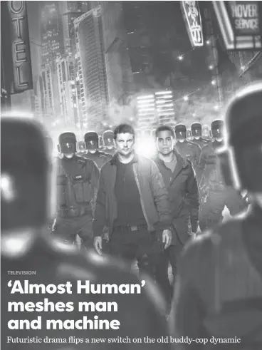  ?? FOX ?? Karl Urban, left, and Michael Ealy play a human cop and his “synthetic” partner in Fox’s Almost Human, a police drama set in the year 2048. The series, which premieres Sunday, is from the team behind Fringe. Urban and Ealy work on developing a friendly...