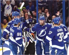  ?? PICTURE: USA TODAY Sports ?? Tampa Bay Lightning centre Steven Stamkos (centre) is congratula­ted by right wing Nikita Kucherov (no 86), defenseman Victor Hedman, centre Yanni Gourde (right) as he scores a goal against the New York Rangers during the second period at Amalie Arena.