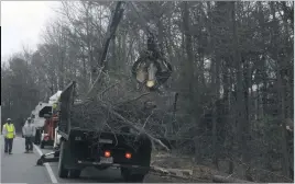  ?? STAFF PHOTO BY MICHAEL SYKES II ?? Cleanup crews along St. Charles Parkway on Monday morning remove sawed wood from the side of the road, part of the aftermath of Saturday’s tornado.