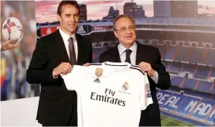  ?? Reuters ?? Real Madrid’s new coach Julen Lopetegui (left) poses with the shirt with president Florentino Perez during the presentati­on on Thursday. —