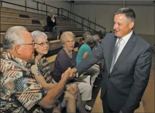  ?? The Sentinel-Record/Richard Rasmussen ?? WAGE BENEFITS: U.S. Rep Bruce Westerman, right, shakes hands with Tracy Coleman, left, with, from left, Judy Coleman and Bobbie Wilson Thursday in the National Park College Wellness Center gym. Westerman was invited to be a special guest speaker for...