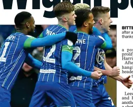  ??  ?? BITTER SWEET: Wigan celebrate after another famous win over Leeds thanks to an Hernandez own goal