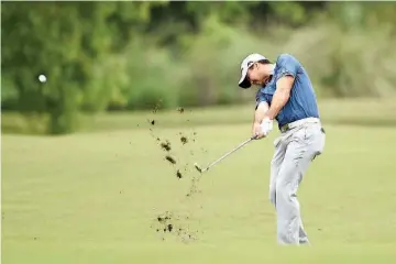  ?? — AFP photo ?? Jason Day of Australia hits his approach shot on the 10th hole during the first round of the Zurich Classic at TPC Louisiana on April 28, 2016 in Avondale, Louisiana.