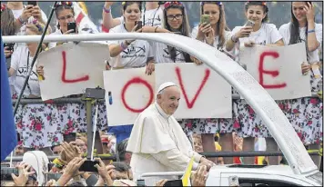  ?? ALIK KEPLICZ / ASSOCIATED PRESS ?? Young people from around the world crowd the streets of Krakow, Poland, on Thursday to get a glimpse of Pope Francis as his motorcade takes him to a pep rally. The pope’s visit will culminate with World Youth Day on Sunday.