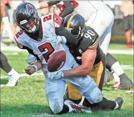  ?? / AP-Gene J. Puskar ?? Pittsburgh Steelers linebacker T.J. Watt sacks Atlanta Falcons quarterbac­k Matt Ryan and forces a fumble that was later recovered for a touchdown in the fourth quarter of an NFL football game on Oct. 7 in Pittsburgh.