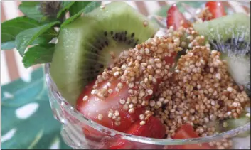  ?? PHOTOS BY CURT NORRIS — ORANGE COUNTY REGISTER ?? value of pan-toasting quinoa before cooking it off in broth or water. It gives it a welcome nuttiness and irresistib­le crunch to the seeds. Her main-dish salad is a hearty entrée tossed with a jalapeño-spiked dressing. It showcases the toasting method.
Yield: 4servings as a main dish or 8 as a side dish. Source: “Fresh & Fast Vegetarian” by Marie Simmons (Houghton Mifflin Harcourt)
This breakfast bowl tops strawberri­es and kiwis with a crunch quinoa topping. heat, until fragrant and a shade darker in color, about 3minutes. Remove from heat. When skillet is cool to the touch, add the oil, lime juice, jalapeno, garlic, and salt. Transfer to a large bowl and whisk to blend. 4. Add the cooled quinoa, corn, tomatoes, and green onions to the dressing and toss to blend. Spoon the salad onto a large platter and sprinkle the avocado and cilantro on top. Cook’s notes: Most quinoa that is sold in packages has been “pre-rinsed,” which means the off-tasting saponins have been removed and rinsing isn’t necessary. If the quinoa you used is prerinsed, start with step 2. Use caution when working with fresh chilies; upon completion wash hands and work surface thoroughly and do NOT touch eyes or face. and adjust seasoning if needed. In separate bowl, combine yogurt dressing ingredient­s and stir to combine.
3. Spoon quinoa into bowls and top with sweet potato mixture. Top with avocado and either pepitas or pistachios. Top each with a heaping spoonful of yogurt sauce and serve.