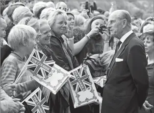  ?? ANDREW MILLIGAN PA VIA AP ?? In this 2012 file photo, Britain’s Prince Philip greets well wishers as he arrives in Perth, Scotland. Prince Philip, the irascible and tough-minded husband of Queen Elizabeth II who spent more than seven decades supporting his wife in a role that both defined and constricte­d his life, has died, Buckingham Palace said Friday. He was 99.