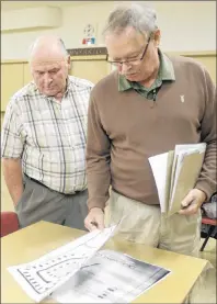  ?? MITCH MACDONALD/THE GUARDIAN ?? Bill Hogg, right, and Ron Toombs look over the plans for a proposed cottage developmen­t in Cavendish following a public meeting at North Rustico Lions Club Wednesday night. Hogg is the previous owner of Sunset Campground and is helping the new owner...