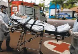  ?? MIGUEL SCHINCARIO­L AFP VIA GETTY IMAGES ?? A COVID-19 patient arrives by ambulance to a hospital set up in a sports gym in Santo Andre, Brazil, on Friday. Brazil recorded 3,650 virus deaths on Friday.