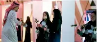  ?? AFP ?? Women distribute flowers to incoming attendees of the Quality of Life Programme 2020 in the Riyadh. —