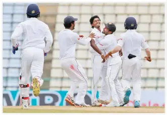  ??  ?? GOT HIM: Sri Lankan team members celebrate the dismissal of Australia's Joe Burns, with their bowler Lakshan Sandakan, center, on day four of the first Test cricket match in Pallekele, Friday. (AP)