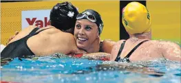  ?? KOJI SASAHARA
THE ASSOCIATED PRESS ?? Canada's Kylie Masse, centre, celebrates after winning the women's 100-metre backstroke final at the Pan Pacific Swimming Championsh­ips in Tokyo on Friday.