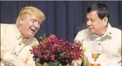  ?? AFP ?? Donald Trump and Rodrigo Duterte in conversati­on at a celebratio­n dinner for the Asean Summit in Manila on Sunday.