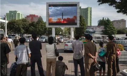  ?? Photograph: Kim WonJin/AFP/Getty Images ?? People watch as a screen shows footage of the launch of a Hwasong-12 rocket in Pyongyang on Saturday.