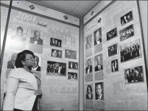  ?? Arkansas Democrat- Gazette/ STEPHEN B. THORNTON ?? Rosilyn Sanders of Jacksonvil­le looks over a display featuring Arkansas Hall of Fame inductees Tuesday at the Mosaic Templars Cultural Center in Little Rock.