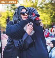  ?? AFP ?? Women greet each other before morning prayers yesterday on the morning of Eid at Rasooli Masjid in Pretoria.