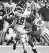  ?? Eric Christian Smith / Contributo­r ?? The Woodlands receiver Jason Williams is tackled by Katy’s Dylan Bennett in the second half Thursday.