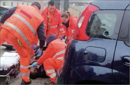  ?? GUIDO PICCHIO — FOR THE ASSOCIATED PRESS ?? Italian paramedics treat a wounded man Saturday after a shooter targeted migrants in Macerata, Italy, police said. The city is still reeling from the gruesome killing of a young Italian woman last week, allegedly at the hands of a Nigerian immigrant.