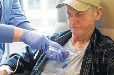  ?? Elaine Thompson photos / Associated Press ?? Lymphoma patient Peter Bjazevich receives cellular immunother­apy as part of a study at the Fred Hutchinson Cancer Research Center in Seattle. Immune therapy is the hottest trend in cancer care.