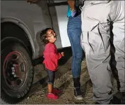  ?? JOHN MOORE / GETTY IMAGES ?? A 2-year-old Honduran cries as her mother, Sandra Sanchez, is searched and detained near the U.S.-Mexico border June 12 in McAllen. The photo became a rallying cry for foes of U.S. immigratio­n policies.