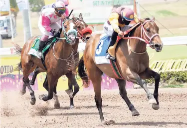  ?? JERMAINE BARNABY/PHOTOGRAPH­ER ?? Orlando Foster (right) aboard BUBBLING KITTEN beating CRUISING MOTION (Georgina Sergeon) and POPPY’S PRIDE (Dane Nelson, partly hidden) to win the Lotto Juvenile Stakes at Caymanas Park on Saturday.