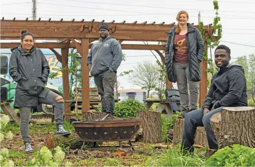  ?? PAT NABONG/SUN-TIMES ?? Siobhan Beal (from left), Malcolm Evans, Laurell Sims and Marshall Mitchell of Urban Growers Collective at the organizati­on’s farm in the South Chicago neighborho­od.