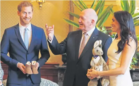  ?? Picture: PA. ?? Governor General Peter Cosgrove gives the Duke and Duchess of Sussex a toy kangaroo and a pair of children’s boots at Admiralty House in Sydney on the first day of the royal couple’s visit to Australia.