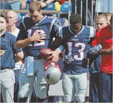  ?? STAFF PHOTO BY MATT WEST ?? HEARTFELT: Tom Brady locks arms with wide receiver Phillip Dorsett during the national anthem before Sunday’s game Patriots game in Foxboro.