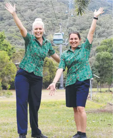  ?? Picture: BRENDAN RADKE ?? READY TO RIDE: Employees Amanda Heiner and Ashlee Oxenham are preparing to welcome guests back when Skyrail reopens next month.