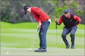  ?? KEVIN KOLCZYNSKI/AP FILE PHOTO ?? Tiger Woods watches as his son, Charlie, putts on the second green during the final round of the 2022 PNC Championsh­ip in Orlando, Fla. They’re back playing this year.