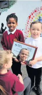  ??  ?? Proud Youngsters at St Margaret’s Primary get to grips with the prestigiou­s award
