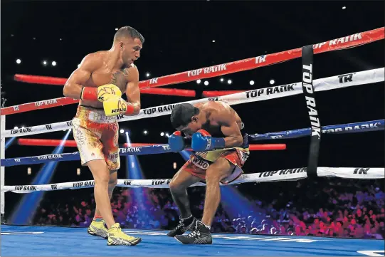  ?? Picture: GETTY IMAGES ?? HEAVY LEATHER: Vasyl Lomachenko, left, of Ukraine sends Miguel Marriaga of Columbia reeling during their WBO junior lightweigh­t title fight