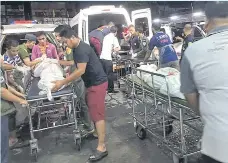  ?? AFP ?? The bodies of some of the people killed in an attack by suspected militants on a checkpoint are brought to a hospital in Yala.