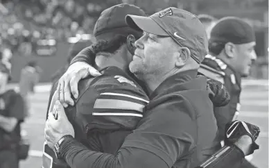  ?? STEPHEN R. SYLVANIE, USA TODAY SPORTS ?? UNLV head coach Barry Odom embraces UNLV quarterbac­k Cameron Friel (7) after the Rebels defeated Colorado State Rams 22-20 at Allegiant Stadium.