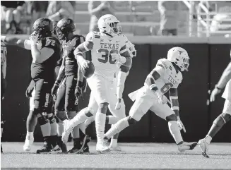  ??  ?? Texas defensive lineman Jacoby Jones (36) celebrates a fumble recovery in the first quarter in a 41-34 overtime win Saturday at Oklahoma State. [SARAH PHIPPS/ THE OKLAHOMAN]