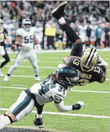  ?? BILL FEIG THE ASSOCIATED PRESS ?? Saints wide receiver Michael Thomas pulls in a touchdown reception against Philadelph­ia Eagles cornerback Cre’von LeBlanc in the second half of an NFL divisional playoff game in New Orleans on Sunday.