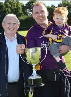  ??  ?? The Harrells - Tommy, son Martin and grandson Oisín, with the championsh­ip trophy.