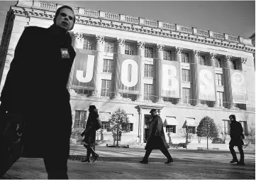  ??  ?? A ‘Jobs’ banner hangs outside the US Chamber of Commerce in Washington, D.C.,on Jan 8, 2014.