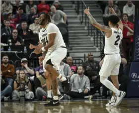  ?? AARON ONTIVEROZ — THE DENVER POST ?? Eddie Lampkin Jr. (44) and KJ Simpson (2) of the Colorado Buffaloes celebrate a jump ball during the second half of CU’S 72-58 win over the Utah Utes at T-mobile Arena in Las Vegas, Nevada on Thursday, March 14, 2024. The Buffs advance to the PAC-12 Tournament semifinal with a matchup against Washington State Friday.